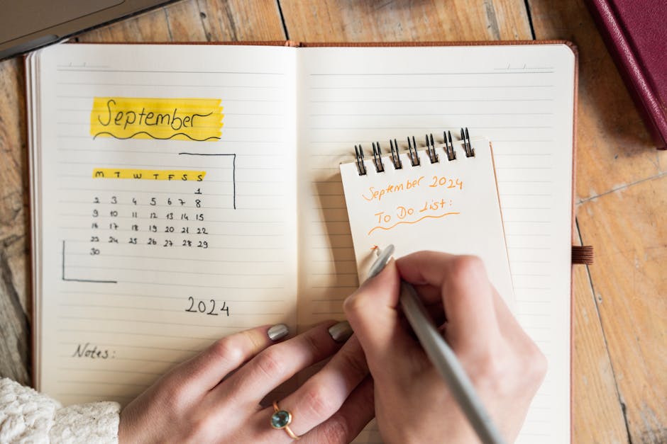 Close-up of a woman writing a to-do list for September 2024 in a notebook. Concept of organization.