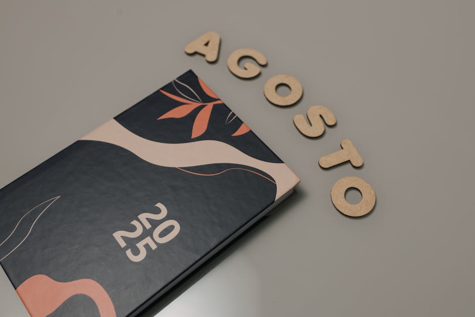 Artistic 2025 planner with decorative elements and 'Agosto' letters, perfect for creatives.