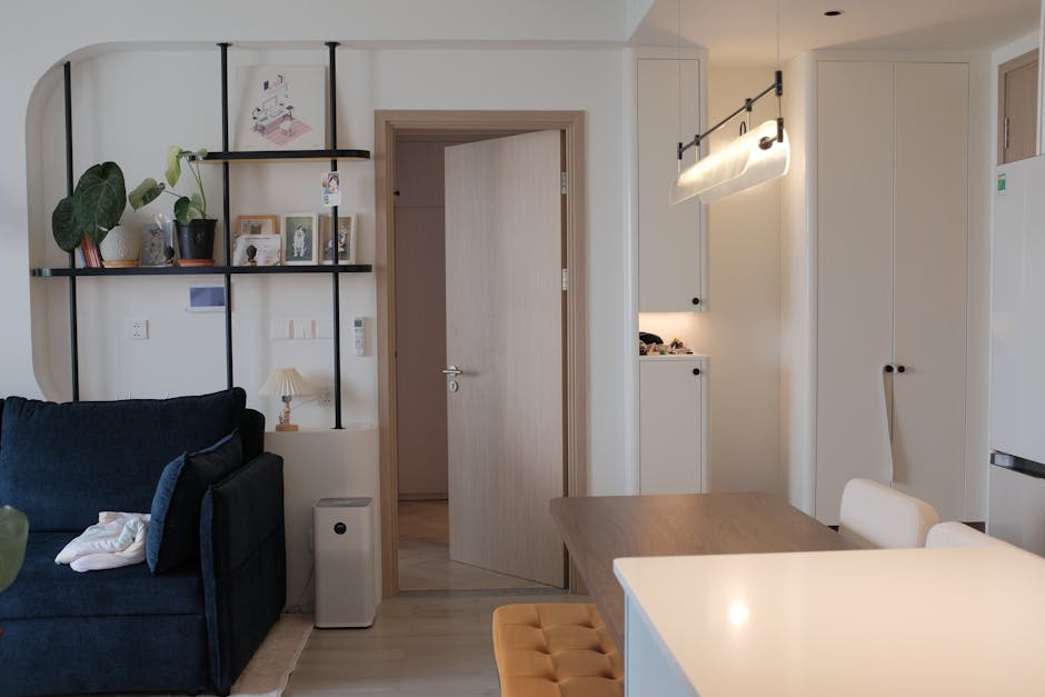Stylish modern living room and kitchen space with elegant decor and lighting.