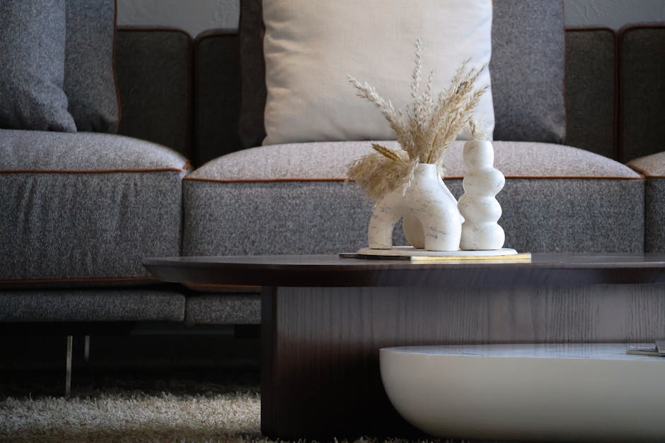 Elegant living room with modern decor featuring stylish vases and a cozy sofa.