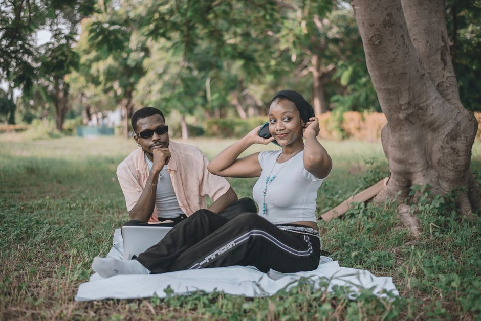 Young couple enjoying a relaxing day outdoors in a park during summer.