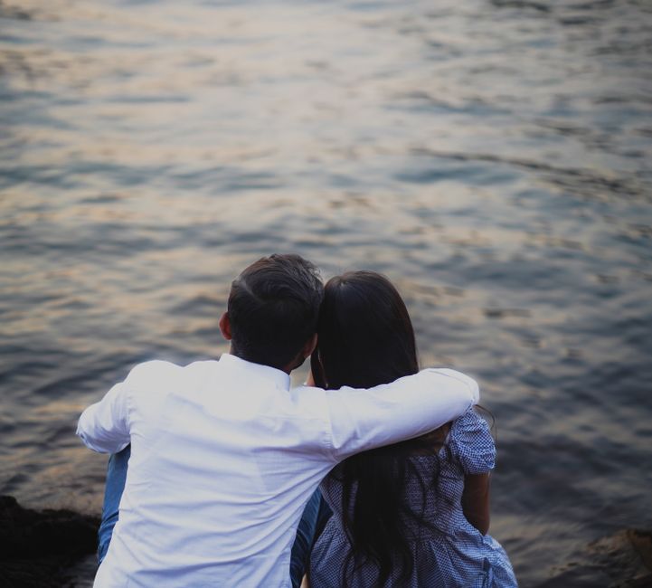 A couple enjoying a serene moment by the lakeside during sunset in Pune, India.