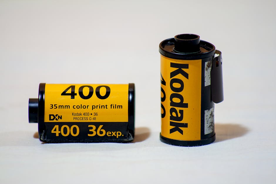 Close-up of Kodak 400 35mm color print film rolls against a white background.